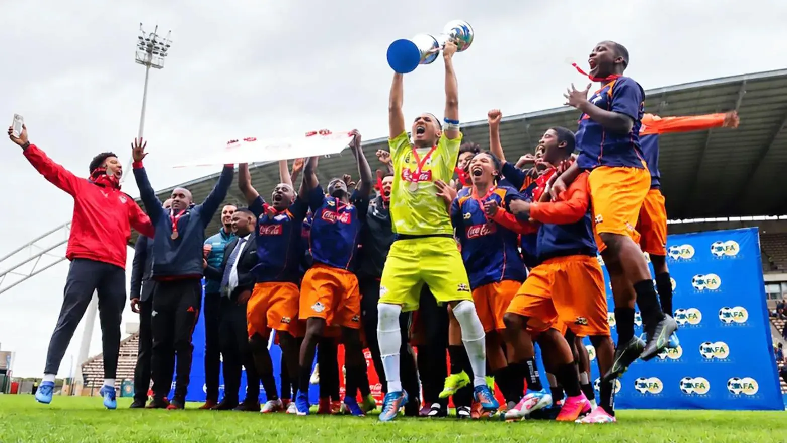 Rising Stars goalkeeper Alonso Juta and his team mates ce;ebrate being crowned Coke Cup champions 2026, at Athlone Stadium, on Saturday