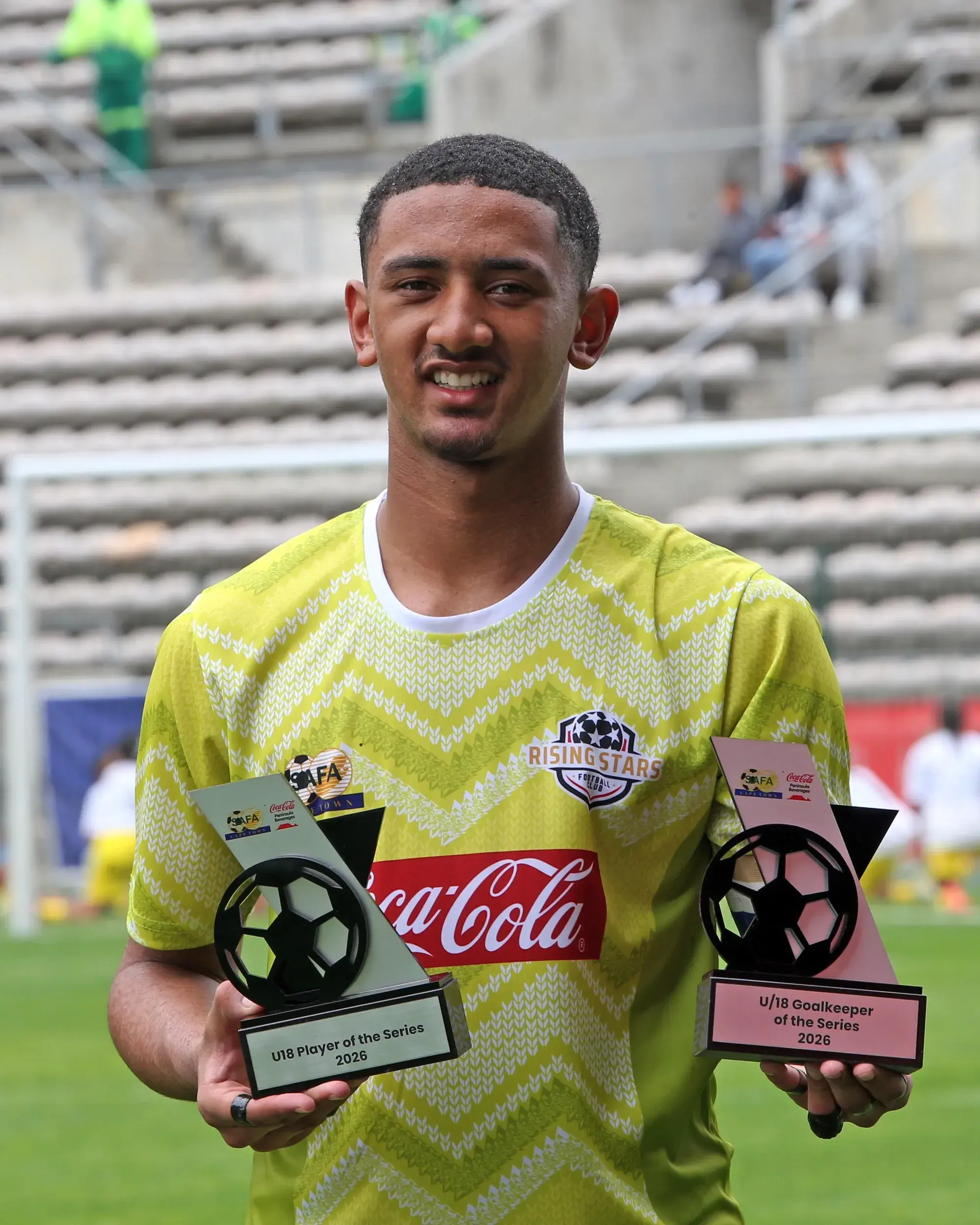 Rising Stars goalkeeper Alonso Juta poses for a picture after being named Player-of-the-Series and Goalkeeper-of-the-Series in the under-18 division of the Coke Cup at Athlone Stadium on Saturday.
